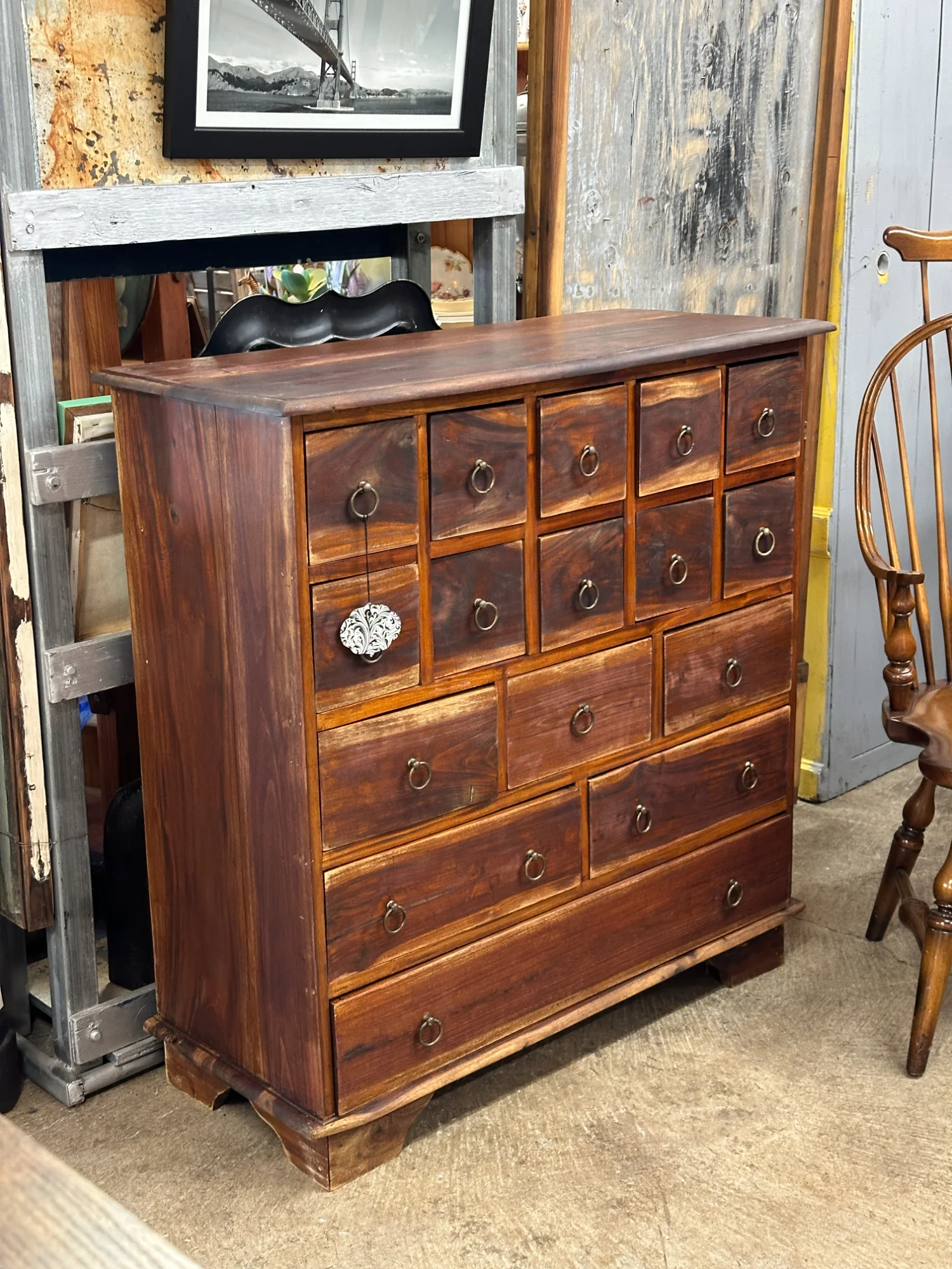 Antique wooden apothecary chest with multiple drawers and brass ring pulls
